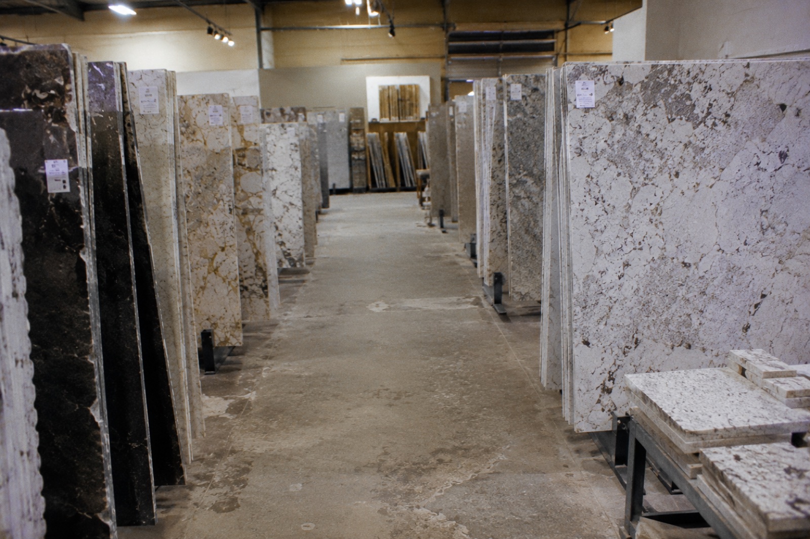 Rows of natural stone slabs in the Copperhead showroom